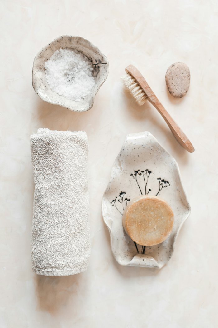 Body brush, soap and towel arranged for a personal care routine