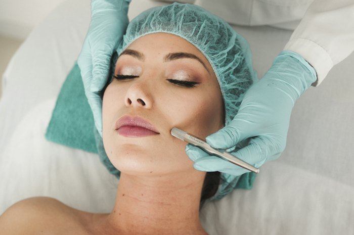 Woman relaxing during a professional facial treatment