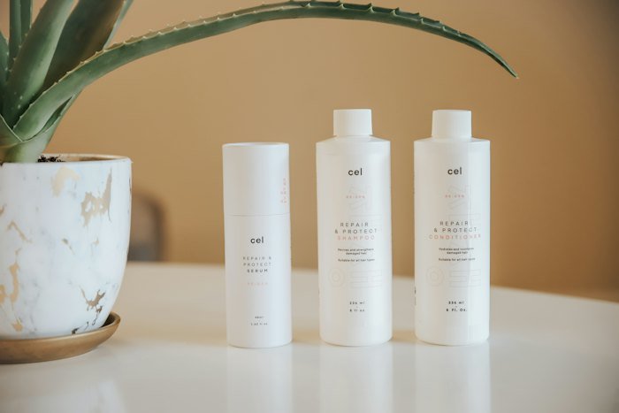 Skincare bottles on a vanity in front of a round mirror