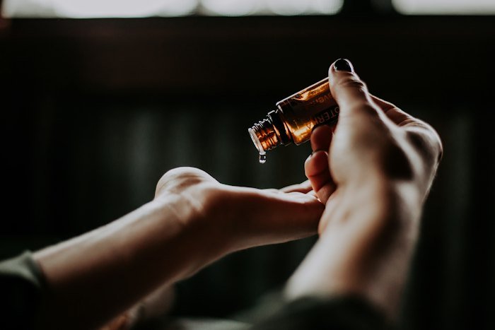 Serum dropper above an open hand